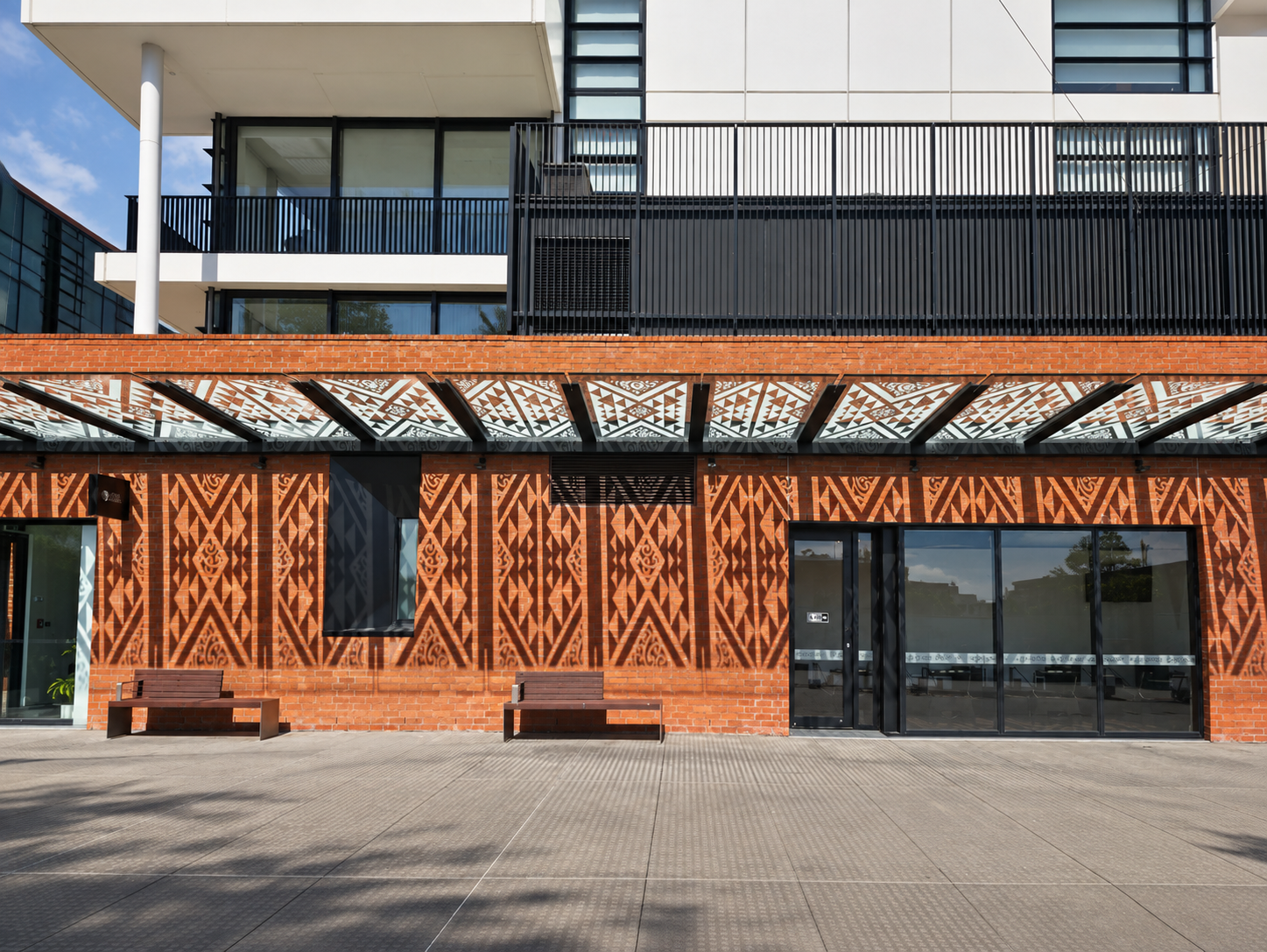 Blank brick frontage at street level with no advertising in place